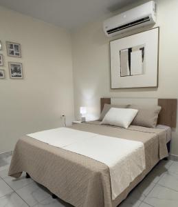 a bedroom with a bed and a air conditioner on the wall at Lodge Ayla Punta Mango in Jucuarán +25 photos
