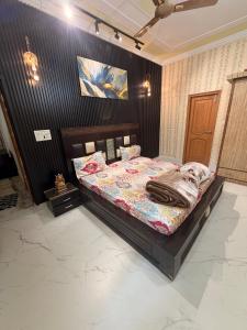 a bedroom with a bed in a room at Meraki Homes in Karnal +4 photos