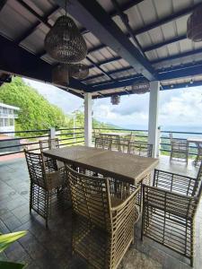 a table and chairs with a view of the ocean at Speranza Hotel & Restaurant in Infanta