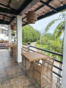 a table and chairs on a balcony with a view at Speranza Hotel & Restaurant in Infanta