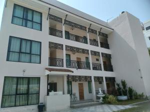 a white building with balconies on it at ขุนโลหะ K̄hun loh̄a in Phuket