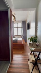 a bedroom with a bed and a wooden floor at Speranza Hotel & Restaurant in Infanta