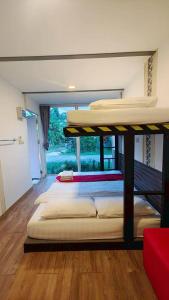 two bunk beds in a room with a window at innbox Chiangmai Hotel in Ban Si Ngam