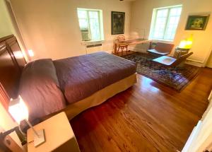 a bedroom with a large bed and a desk at 2 Born Wealthy in 1926 in Elkins Park