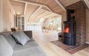 a fireplace in a living room with a couch at Beautiful Home In Ans By in Roe