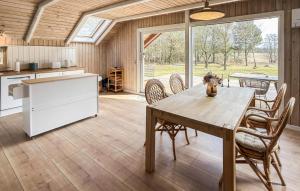 a kitchen and dining room with a table and chairs at Beautiful Home In Ans By in Roe