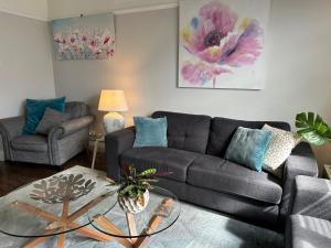a living room with a couch and a table at Daisy Cottage on Duke 2BR in Yarram