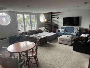 a living room with a couch and a table at Cozy cottage on the River in Port Dover