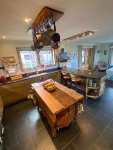 a kitchen with a large wooden table in a kitchen at Grunkeys - PLEASE NOTE these are rooms in my home, not a separate property in Orkney