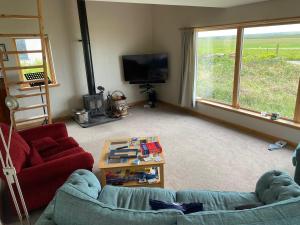 a living room with a couch and a tv at Grunkeys - PLEASE NOTE these are rooms in my home, not a separate property in Orkney