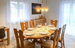 a dining room with a table with chairs and a dining room at 3 Bedroom Amazing Home In Mutigney in Mutigney