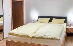 a large bed in a room with two lamps at 3 Bedroom Amazing Home In Mutigney in Mutigney +13 photos