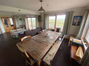 a living room with a wooden table and a couch at Grunkeys - PLEASE NOTE these are rooms in my home, not a separate property in Orkney