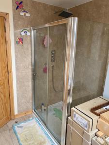 a shower with a glass door in a bathroom at Grunkeys - PLEASE NOTE these are rooms in my home, not a separate property in Orkney +110 photos