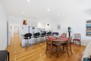 a kitchen and dining room with a table and chairs at Tide & Town - Perfectly Located! in Inverloch +10 photos