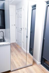 a mirror in a kitchen with a sink at Cozy Apartment in Dublin +6 photos