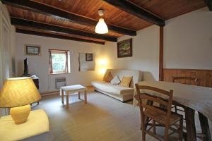 a living room with a couch and a table at Claveyrolas in Nedde