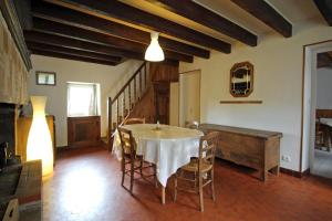 a dining room with a table and chairs and a staircase at Claveyrolas in Nedde +17 photos