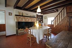 a dining room with a table and a fireplace at Claveyrolas in Nedde