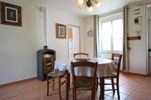 a dining room with a table and chairs at Les soleils in Nedde +17 photos