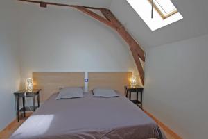 a bedroom with a large bed with two night stands at Mazeau nicot in Nedde
