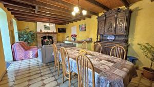 a kitchen and dining room with a table and chairs at Péret in Saint-Denis-des-Murs +15 photos