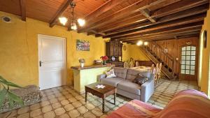 a living room with a couch and a table at Péret in Saint-Denis-des-Murs