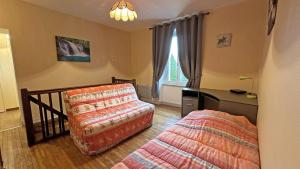 a bedroom with a couch and a bed and a window at Péret in Saint-Denis-des-Murs