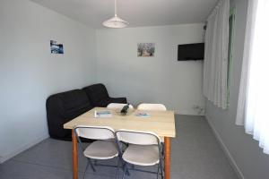 a living room with a table and two chairs at Gîte 87G5501 in Bujaleuf +8 photos