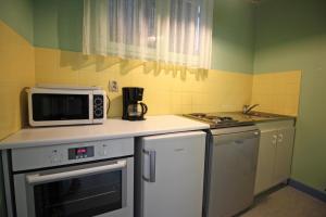 a small kitchen with a microwave and a stove at Gîte 87G5501 in Bujaleuf