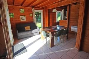a room with a table and chairs and a couch at Gîte 87G5511 in Sussac
