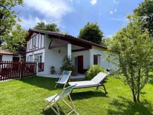 a yard with two chairs and a house at Hartzurienea in Anhaux