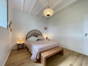 a bedroom with a bed and a bench in it at Hartzurienea in Anhaux