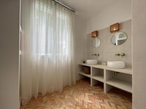 a bathroom with two sinks and two mirrors at Hartzurienea in Anhaux +38 photos