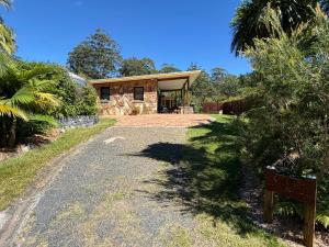 a house with a gravel road leading to it at Coffs Coast Mountain Retreat Cabin 1 in Coramba