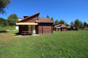 a small house with a picnic table in a field at Gîte 87G5513 in Sussac +15 photos