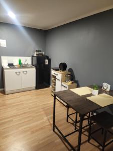 a room with a table and a kitchen with a counter at Tiny por trabajo in Trinidad +2 photos