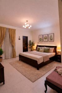 a large bedroom with a large bed and a couch at Pine Galaxy in Bhowāli