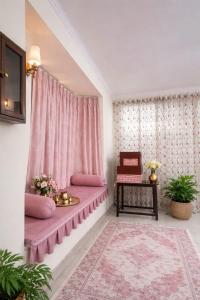 a room with a purple couch in a room with a window at Pine Galaxy in Bhowāli
