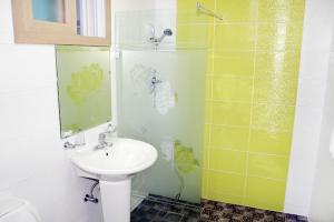 a bathroom with a sink and a shower at Zain Village pension in Seogwipo +30 photos