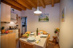 a kitchen with a table with a white table cloth at Appartamento Centro Storico Riva - Happy Rentals in Riva del Garda +12 photos
