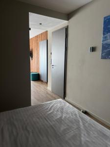 an empty room with a bed and a hallway at Avenue Chalet in Špindlerův Mlýn +54 photos