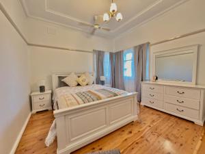a bedroom with a large bed and a large mirror at 72 Cobra Street House in Dubbo