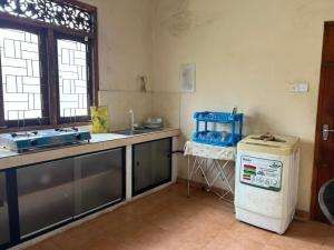 a kitchen with a sink and a refrigerator in a room at Villa 87 in Katunayaka