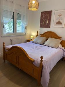 a bedroom with a large wooden bed with white sheets at Las estrellas in Peniscola +29 photos