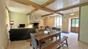 a living room with a dining table and a couch at Cirèges in Le Chalard