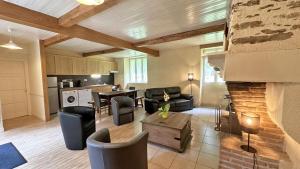 a living room with a couch and a table at Cirèges in Le Chalard