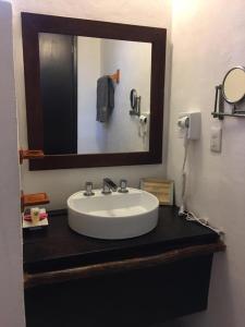 a bathroom with a sink and a mirror on a counter at Lodge Arenas Costa Maya in Mahahual