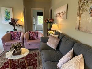 a living room with a couch and two chairs at Bush Retreat Farm Stay 1BR Guest Suite in Alberton West