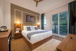 a bedroom with a bed and a large window at Hotel Mountain Mirage in KumhÄrsain +17 photos